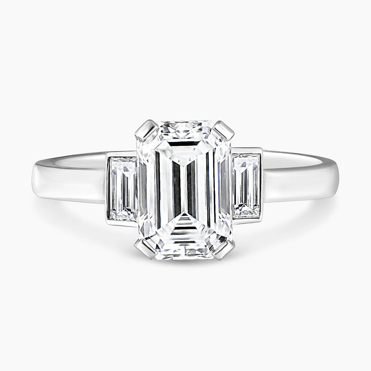 Platinum 1.81ct emerald cut diamond ring in four claw set with baguette diamonds in bezel set